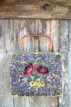 an old purse hanging on the side of a wooden wall