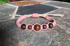 *Please read below for sizing and item details* Beaded hemp bracelet.  Made with soft natural hemp.  This piece is adjustable from 6" at its smallest to 10" at its largest. It's made using a square knot design with a 1mm dusty pink hemp on a 2mm natural colored hemp base. It features five wooden accent beads at the center.  The pink hemp 1mm thickness with a 2mm natural colored hemp core giving it a 3/8" width.  Everyone is different so be sure to measure your wrist/ankle to insure a comfortable Hippie Bracelet, Hemp Bracelet, Hemp Jewelry, Hemp Bracelets, Square Knot, Hippie Bracelets, Knot Design, Boho Bracelet, Bracelet Boho