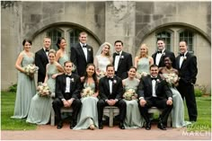 a group of people in formal wear posing for a photo