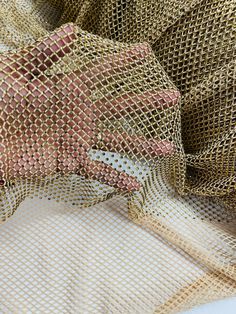 a piece of cloth that is covered in gold mesh