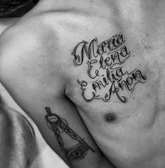 black and white photo of a man's chest with his name tattooed on it