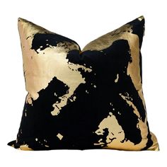 a black and gold pillow on a white background