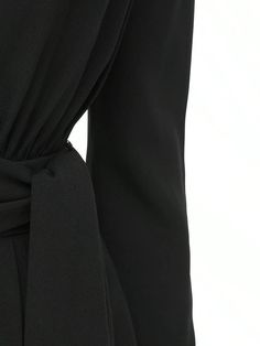 Deep V neckline. Long sleeves. Padded shoulders. Concealed back hook and zip closure. Includes matching belt. Fitted waist. Two side pockets. Lined. Model is wearing a size36 Chic Jumpsuits And Rompers With Belt For Workwear, Elegant Fitted Jumpsuit With Back Zipper, Elegant Fitted Jumpsuits And Rompers With Back Zipper, Fitted Elegant Jumpsuits And Rompers With Back Zipper, Elegant Belted Jumpsuits And Rompers, Elegant Workwear Dresses With Belt Loops, Belted Long Sleeve Jumpsuits For Work, Belted Long Sleeve Jumpsuits And Rompers For Work, Elegant Jumpsuits With Belted Cuffs