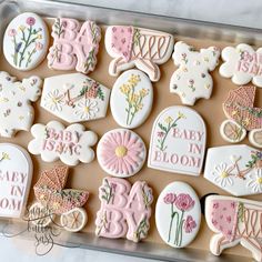 baby shower cookies decorated with pink and white icing on a cookie sheet in a box