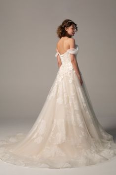 the back of a wedding dress with an off - shoulder, lace and tulle