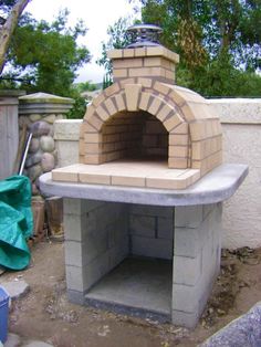 an outdoor brick pizza oven built into the side of a building