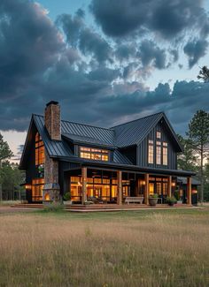 a large house sitting on top of a lush green field under a cloudy blue sky