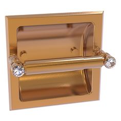 a gold toilet paper holder with two crystal knobs