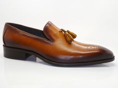 Style: 503-47-Cognac Elegant Burnished Calfskin slip-on Tasseled Loafer from the Carrucci collection features Decorative Perforations with a Toe Medallion and a clean welt!