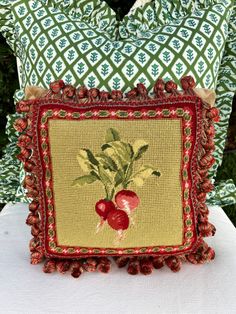 a decorative pillow with a radish on it sitting on top of a white table