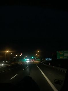 cars driving down the highway at night time