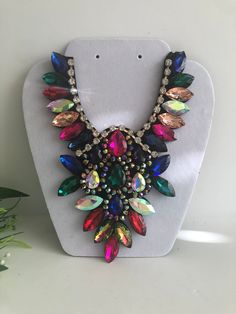 "Beautiful  multicolor statement  necklace  shine and bright for any special occasional  Necklace statement 5.5\" wide. 8\" height with 30\" extender Closure: ribbon tie Adjustable length  Return & exchanges We gladly accept cancellations Request a cancellation within 4 hour of purchase.  We don't accept return or exchanges but please contact us if You have any questions or any problem with your orders Thank you for shopping with us ♥️ Stay safe & healthy" Affordable Multicolor Long Necklace, Luxury Multicolor Necklace With Large Beads, Multicolor Rhinestone Necklace For Party, Multicolor Rhinestone Costume Necklace For Parties, Multicolor Rhinestone Costume Necklace, Multicolor Costume Jewelry Bib Necklace For Party, Colorful Costume Jewelry Necklaces For Party, Oversized Necklace, Bold Statement Necklaces