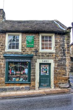 an old stone building with a green door