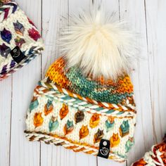 multicolored knitted hat with white fur pom