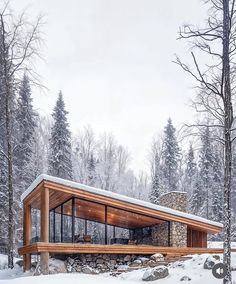 a cabin in the woods with snow on the ground and trees around it, surrounded by rocks