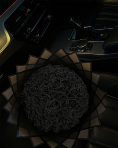 the interior of a car is decorated with black roses and other decorative items, including steering wheel controls