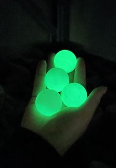 glow in the dark hands holding glowing balls