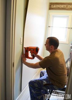 a man sitting on a chair holding an electric drill