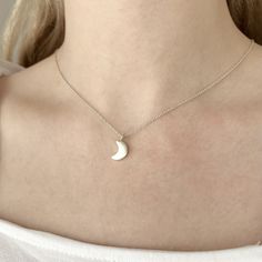 Sterling Silver Celestial Crescent Moon Charm Necklace  This necklace features the sweetest crescent moon charm on dainty but sturdy sterling silver cable chain. The charm is about 13mm long (including the loop) and about 7mm wide and it has a brushed texture for some subtle matte sheen. The charm is about 2mm thick so it has some nice depth to it and it slides freely along the chain for a simple minimalist design that would complement both casual and dressy outfits. Celestial jewelry is always in style so the necklace would be a perfect everyday accessory and it's charming on its own or layer it with others for a trendy look. The necklace is fastened with a sterling spring ring clasp and you can choose your desired length from the drop-down menu above.  You can find more celestial jewelry Lunar Jewelry, Crescent Moon Necklace Silver, Necklace Everyday, Celestial Necklace, Crescent Moon Necklace, Celestial Jewelry, Everyday Necklace, Necklace Minimalist, Silver Moon