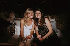 two beautiful women sitting next to each other