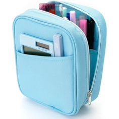 a blue case with pens, pencils and other items in it on a white background