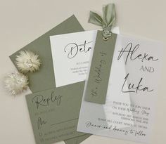 the wedding stationery is laid out on top of each other, with a flower