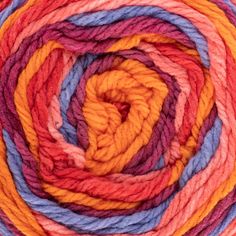 multicolored skeins of yarn are arranged in a spiral pattern on top of each other