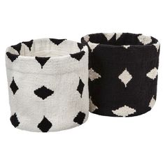 two black and white knitted baskets sitting next to each other