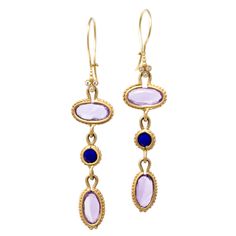 Royal, regal and rich in jewel tones, these earring will make you feel like an Empress. Amethyst is known as a stone of peace and unification. It is also thought to evoke feelings of serenity and calmness in those who wear it. Our 14k gold Clover earrings feature oval, rose cut amethysts and round rose cut lapis lazuli accented by full cut white diamonds. Pictured in:14k yellow gold4.4ct amethyst.60ctw lapis lazuli.03ctw full cut white diamonds2" length Jennifer Dawes Design curates the most bea Purple Oval Fine Jewelry Earrings, Luxury Purple Multi-stone Earrings, Elegant Purple Multi-stone Gemstones, Elegant Tanzanite Dangle Earrings, Elegant Amethyst Drop Earrings, Elegant Oval Amethyst Earrings, Elegant Amethyst Purple Earrings, Elegant Purple Amethyst Earrings, Oval Amethyst Earrings With Gemstone Accents