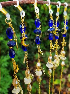 Elevate your eyewear game with our new glasses chain featuring a stunning combination of blue lapis lazuli and yellow citrine crystals. This unique glasses chain is perfect for those who love celestial themes, as it features moon, star, and sun charms that will make you feel out of this world! The chain comes in both gold and silver colors, making it a versatile accessory for any outfit. Plus, the amethyst and citrine crystals are believed to bring positive energy and abundance to your life, mak Adjustable Gold Glasses Chains For Gift, Adjustable Gold Glasses Chains As Gift, Gold Glass Glasses Chains Gift, Spiritual Gold Glass Jewelry, Gold Beaded Glasses Chains For Gift, Handmade Blue Glass Glasses Chains, Gold Adjustable Chain Glasses Chains For Festivals, Handmade Glass Glasses Chains In Gold, Blue Glass Jewelry For Festivals