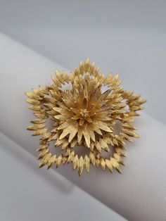 A stunning vintage 1960s Monet brooch. A true beauty to add to your collection. Excellent vintage condition, with no notable imperfections. Signed Monet, with a secure safety clasp. 5.2cm diameter. ------------------ 🏆About the Designer: Vintage Monet jewellery is prized by collectors because of its high quality and design. The triple-plating manufacturing process ensures that Monet jewellery lasts for decades without tarnish. In the 80s and 90s, Monet produced jewellery for Yves Saint Laurent Gold Flower Brooches For Party, Gold Flower Brooch For Formal Occasions, Gold Flower Brooch For Party, Vintage Gold Flower Shaped Brooch, Gold Flower Brooch For Evening, Vintage Yellow Gold Brooches For Party, Gold Flower-shaped Brooches For Wedding, Gold Flower-shaped Wedding Brooches, Gold Wedding Brooches In Flower Shape