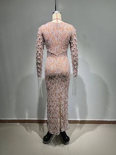 a mannequin wearing a pink dress with chains on it's neck and sleeves