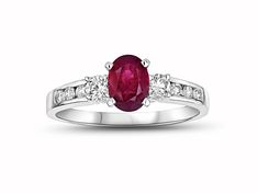 Ruby and Diamond Engagement Ring in 14k White Gold. This engagement ring has a 7x5mm oval Ruby in the center and has 0.40ctw of diamonds. Oval Ruby Ring With Platinum Center Stone, Oval Ruby Ring With Platinum Band, Oval Three Stone Ruby Ring With Diamonds, Oval Ruby Ring With Platinum, Oval Ruby Ring With Platinum Setting, Oval Ruby Ring With Three Diamonds, Oval Diamond Ring With Side Stones For Promise, Oval Diamond Promise Ring With Side Stones, White Gold Oval Rings With Side Stones