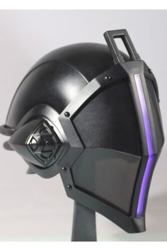 a futuristic helmet is shown with purple light on the side and black, metal casing