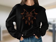 Embrace the Halloween spirit with our Vintage 90s Style Bat Sweatshirt--where retro meets spooky in perfect harmony. This Y2K-inspired unisex shirt is not just a seasonal piece; it's a timeless expression of your unique style and love for all things dark and mystical. Crafted from a cozy and soft fabric blend, this sweatshirt ensures you stay warm while making a fashion statement. The dark, spooky bat design adds a touch of gothic charm, perfect for Halloween parties, casual outings, or cozy nig Y2k Cotton Sweatshirt For Halloween, Y2k Halloween Graphic Print Sweatshirt, Y2k Graphic Print Halloween Sweatshirt, Y2k Graphic Print Sweatshirt For Halloween, Long Sleeve Halloween Concert T-shirt, Halloween Concert Long Sleeve Tops, Long Sleeve Tops For Halloween Concert, Alternative Halloween Crew Neck Top, Alternative Crew Neck Halloween Tops