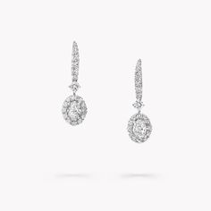 A gleaming pavé diamond halo frames two elegant centre stones in our Icon earrings in white gold, enhancing the captivating play of light that emanates from deep within the oval diamonds. Suspended from graceful pavé clips, the diamond detailing is designed to scintillate with the wearer's every movement. Named after the famous Icon diamond – a 90.97 carat round brilliant diamond that was cut and polished by Graff in 2000 – the Icon collection celebrates the incomparable beauty of one of Mother’ Oval Diamond Earring, Diamond Shaped Engagement Ring, Graff Diamonds, Icon Jewelry, Round Diamond Pendant, Round Diamond Earrings, Pave Diamond Earrings, Diamond Earrings Studs Round, Fine Diamond Jewelry