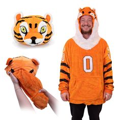 a man in an orange hoodie with a stuffed tiger on his chest and a football helmet to the side