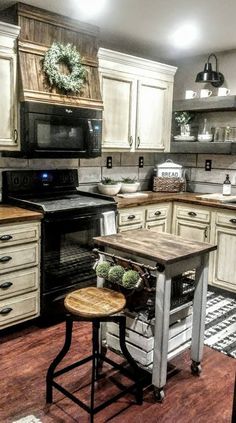 a kitchen with white cabinets and an island that has a wooden table in the middle