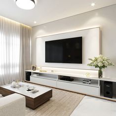 a large flat screen tv mounted to the side of a wall in a living room