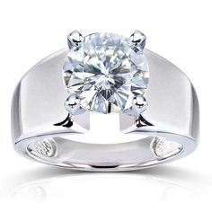 a white gold ring with a diamond in the center