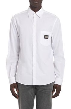 From the Italian label's 'essential' collection comes this crisp white cotton button-up in a slim Martini fit branded with an engraved logo at the chest pocket. 30 1/2" length; 44" chest (size 39) Front button closure Point collar Long sleeves with button cuffs Chest patch pocket 100% cotton Dry clean Made in Italy Men's Designer Clothing Designer White Shirt With Button Cuffs, Classic Cotton Shirt With Functional Buttons, Luxury Cotton Shirt With Button Cuffs, Luxury Cotton Shirt With Button Closure, Designer White Cotton Dress Shirt, Luxury Cotton Slim Fit Tops, Luxury White Cotton Dress Shirt, Luxury Cotton Tops With Buttons, Designer Slim Fit Cotton Dress Shirt