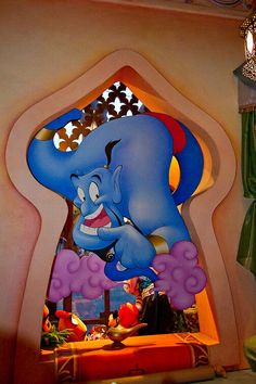 the entrance to an amusement park decorated with cartoon characters and decorations, including an elephant