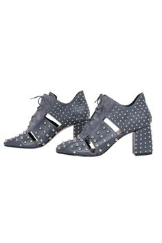 Experience the essence of femininity in these chic studded leather booties from Red Valentino. The suede accent with the lace-up detailing and silver studs will add an edge to any look, while the side cutouts and 3” block heels make them comfortable. Style with a leather mini skirt and a graphic tee for an edgy night out. Size 8 (38 IT) Made in Italy Leather upper Silver studs Almond toe Heel height 3” Leather Heels With Rivets And Round Toe, Winter Studded Heels, Studded Heels For Winter, Fall Studded Ankle Lace-up Boots, Chic Heels With Silver Studs And Round Toe, Fall Ankle Lace-up Boots With Studded Outsoles, Leather Boots With Spikes For Evening, Trendy Leather Heels With Studs, Leather High Heels With Rivets