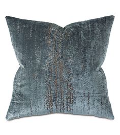 a blue velvet pillow with metallic foil on it