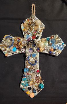 Cross made to hang with loop at the top. Bejeweled with broken pieces of jewelry from my jewelry collection. Unique Rhinestone Jewelry For Gifts, Unique Rhinestone Jewelry Gift, Cross-shaped Jeweled Jewelry Gift, Jeweled Cross Jewelry Gift, Unique Collectible Jeweled Jewelry, Cross-shaped Jeweled Jewelry For Gifts, Jeweled Cross Jewelry For Gifts, Multicolor Beaded Cross Jewelry, Handmade Multicolor Cross Jewelry