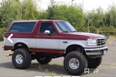 a red and white truck parked in a parking lot