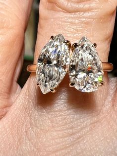 Certified Marquise & Pear Moissanite Toi et Moi (You and Me) Engagement Ring / Test Positive 🪛 Best Seller for 2023-2024!  Love these (you and me) rings.  So sentimental and romantic.  Very comfortable and easy to wear.   Premium quality Moissanite means you are purchasing a diamond which is internally flawless,  D color, made of silicon carbide and will test positive for a diamond.  These gemstones have the same physical, chemical, and optical properties as mined gems do. Mother Earth Moissanite does not "make" gems, but rather controls the environment so that crystals can grow naturally: recreating the conditions in which gems grow in the earth. Certification Included Diamond Weight: 1.5CT Marquise & 1CT Pear Color: D-E  Clarity: VVS1 Metal: 925 SS/ 9K / 14K Moissanite is a gemstone bor Gia Certified Teardrop Ring For Anniversary, Teardrop Diamond Ring With Vs Clarity For Anniversary, Anniversary Teardrop Diamond Ring With Vs Clarity, Pear-shaped Diamond Jewelry For Promise, Gia Certified Teardrop Diamond Ring For Anniversary, Gia Certified Teardrop Diamond Ring For Formal Occasions, Vvs Clarity Pear Shaped Anniversary Ring, Formal Teardrop Wedding Ring With Vvs Clarity, Anniversary Teardrop Moissanite Diamond Ring