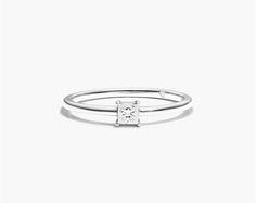 14K White Gold Petite Solitaire Princess Cut Diamond Ring. With symbolic sparkle at the center, this stackable ring is an absolute beauty that will the steal the heart of whoever receives it. Up the sparkle style by pairing it with multiple stackables. Fine Jewelry White Gold Stackable Diamond Ring, Fine Jewelry Princess Cut Stackable Promise Rings, Fine Jewelry Stackable Princess Cut Promise Rings, Timeless White Diamond Stackable Ring, White Stackable Anniversary Rings, White Gold Solitaire Stackable Rings, Stackable White Gold Diamond Promise Ring, Adjustable White Gold Diamond Ring In Fine Jewelry Style, Diamond White Solitaire Stackable Rings