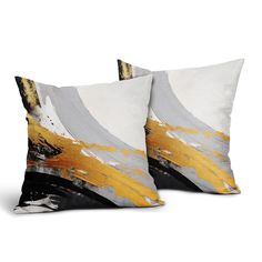 two decorative pillows with yellow and grey designs on them, one in the shape of an abstract painting