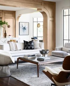 a living room filled with furniture and lots of windows